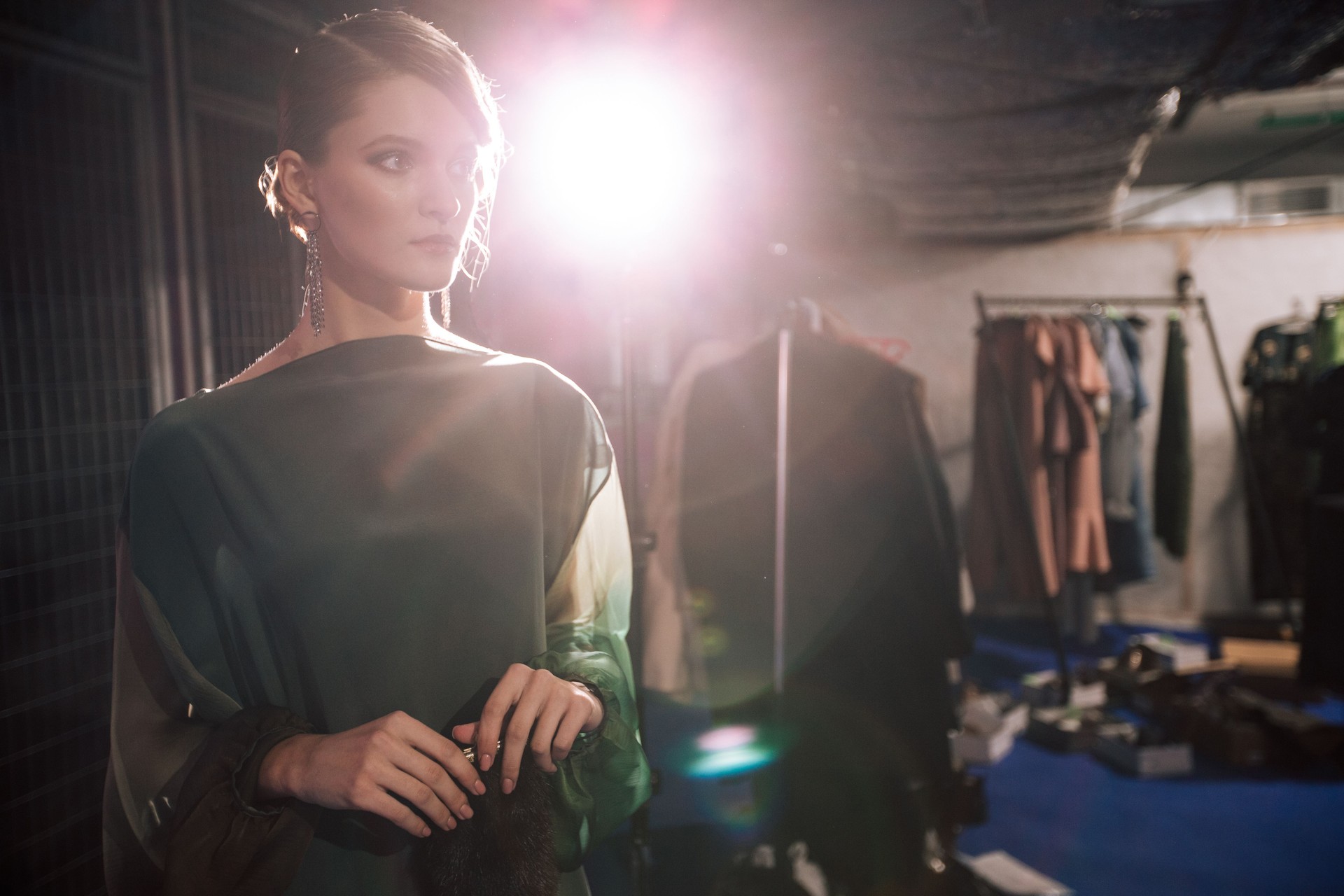 Female portrait of fashion woman at the backstage of fashion week show. Lifestyle photography, behind the scenes of new clothing collection. Girl wear by fashion designer. Haute Couture photo.